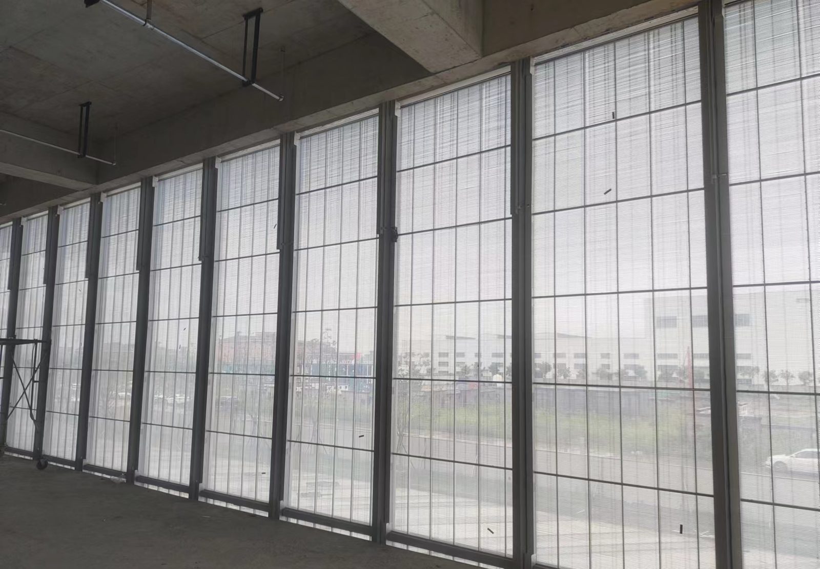 Mur vitré équipé de Vitra sur toute sa hauteur, vu de l'intérieur en journée